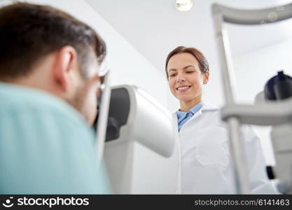 health care, medicine, people, eyesight and technology concept - optometrist with non contact tonometer checking patient intraocular pressure at eye clinic or optics store