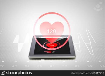 health care, medicine, technology and modern gadget concept - close up of tablet pc computer with heart rate icon on screen over gray background