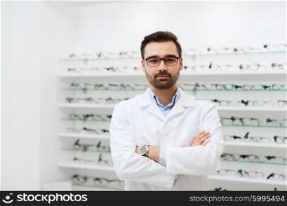 health care, people, eyesight and vision concept - man optician in glasses and white coat at optics store