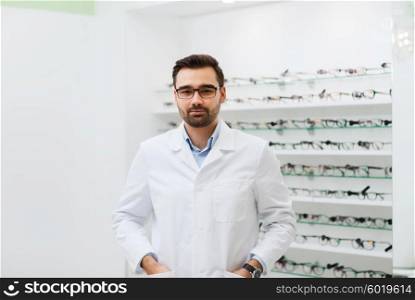 health care, people, eyesight and vision concept - man optician in glasses and white coat at optics store