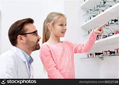 health care, people, eyesight and vision concept - optician and smiling girl choosing glasses at optics store