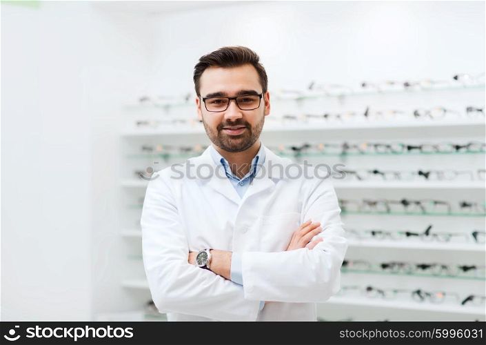health care, people, eyesight and vision concept - smiling man optician in glasses and white coat at optics store