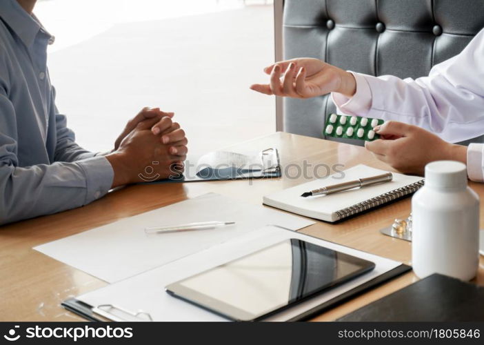 Health care. Professional medical doctor in white uniform gown coat interview consulting patient.