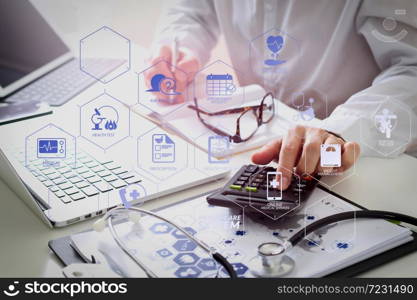 Health care system diagram with health check and symptom on VR dashboard.Healthcare costs and fees concept.Hand of smart doctor used a calculator for medical costs in modern hospital