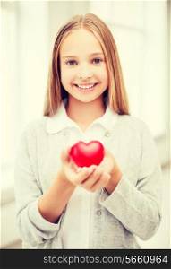 health, charity and beauty concept - beautiful teenage girl showing red heart