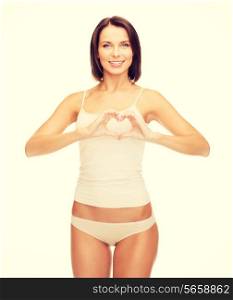 health, charity and beauty concept - beautiful woman in cotton underwear forming heart shape