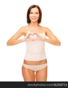 health, charity and beauty concept - beautiful woman in cotton underwear forming heart shape