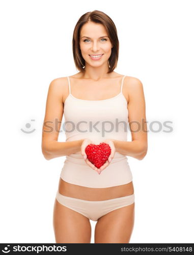 health, charity and beauty concept - beautiful woman in cotton underwear showing red heart