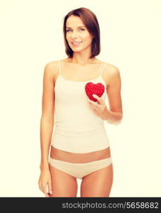 health, charity and beauty concept - beautiful woman in cotton underwear showing red heart