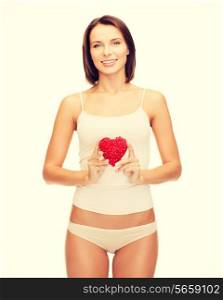 health, charity and beauty concept - beautiful woman in cotton underwear showing red heart