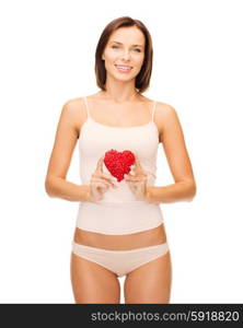 health, charity and beauty concept - beautiful woman in cotton underwear showing red heart