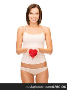 health, charity and beauty concept - beautiful woman in cotton underwear showing red heart