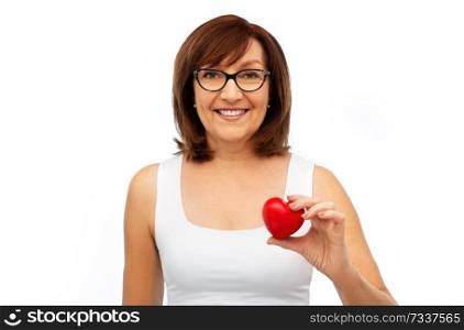 health, charity and valentine’s day concept - portrait of smiling senior woman holding red heart over white background. portrait of smiling senior woman holding red heart