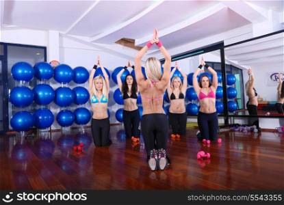 health club: women doing stretching, fitness, aerobics and yoga exercise