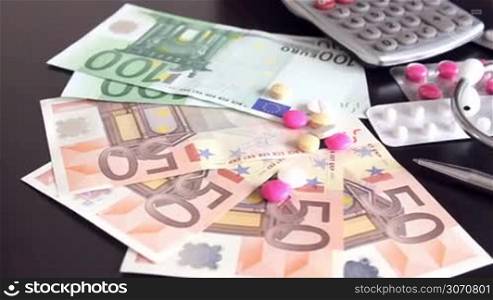 Health costs concept - pills and euro money
