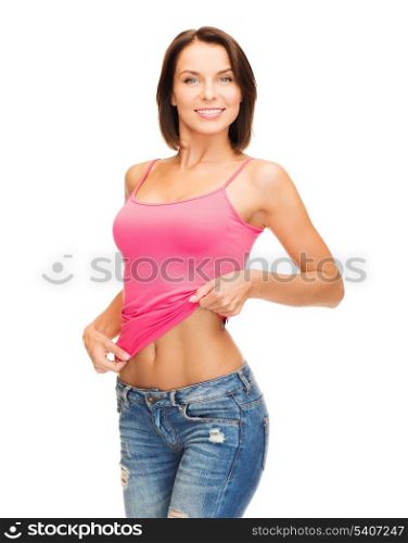 health, diet and beauty concept - happy woman taking off blank pink tank top or showing abs