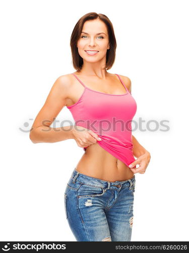 health, diet and beauty concept - happy woman taking off blank pink tank top or showing abs