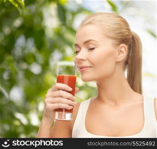health, diet and food concept - close up of young woman drinking tomato juice