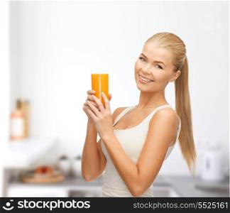 health, diet and food concept - young woman holding glass of orange juice