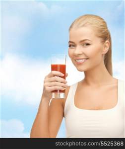 health, diet and food concept - young woman holding glass of tomato juice