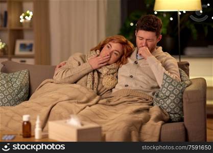 health, flu and people concept - sick young couple coughing at home. sick young couple coughing at home