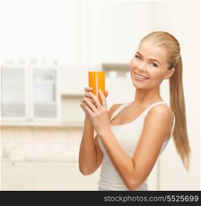 health, food and diet concept - young woman holding glass of orange juice
