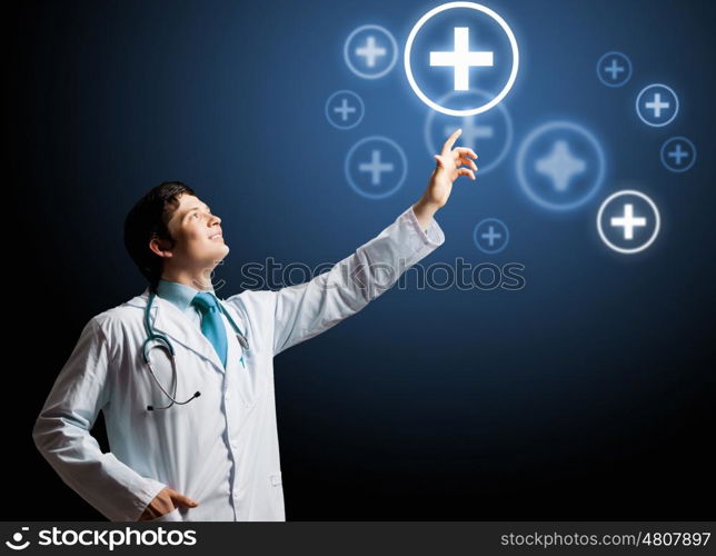 Health guard. Young doctor touching with finger media medical sign