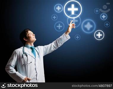 Health guard. Young doctor touching with finger media medical sign
