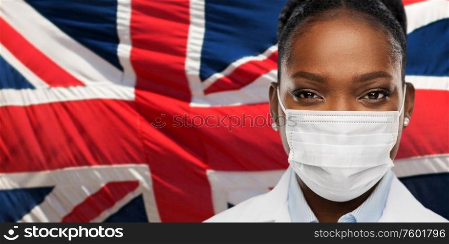 health, medicine and pandemic concept - close up of african american female doctor or scientist in protective medical mask over british flag background. african american doctor in medical mask