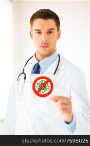 health, medicine and pandemic concept - male doctor holding coronavirus sign. male doctor holding coronavirus sign