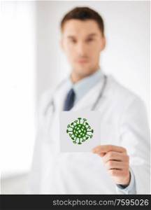 health, medicine and pandemic concept - male doctor holding coronavirus sign. male doctor holding coronavirus sign