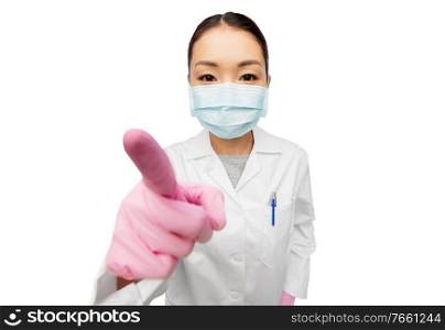 health, medicine and pandemic concept - young asian female doctor or scientist wearing face protective medical mask for protection from virus disease pointing finger to camera. asian female doctor in mask pointing finger to you