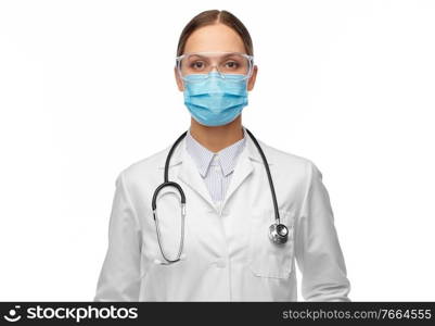 health, medicine and pandemic concept - young female doctor with stethoscope wearing goggles and face protective medical mask for protection from virus disease. female doctor in goggles and medical mask
