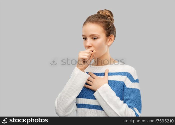 health, medicine and people concept - sick coughing teenage girl in pullover over grey background. sick coughing teenage girl in pullover