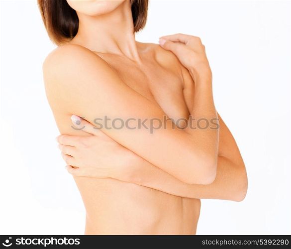health, medicine, beauty concept - topless woman with perfect skin and hands over breast