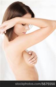 health, medicine, beauty concept - woman checking breast for signs of cancer