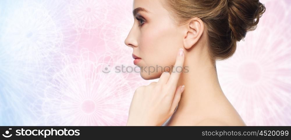 health, people and beauty concept - beautiful young woman pointing finger to her ear over rose quartz and serenity patterned background