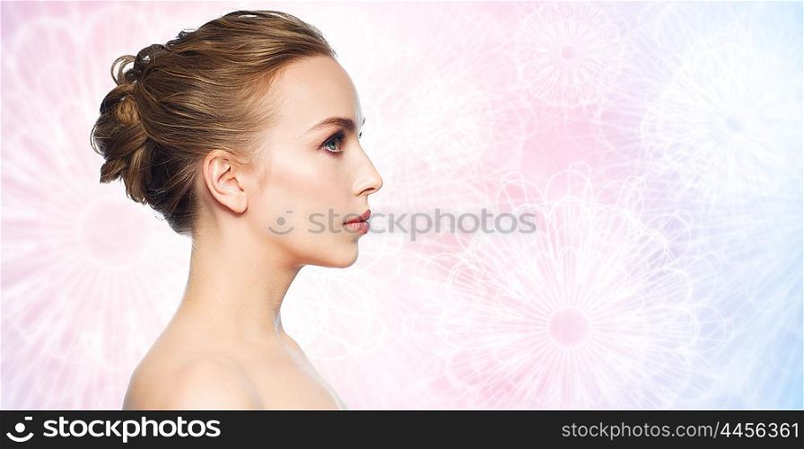 health, people, plastic surgery and beauty concept - beautiful young woman face over rose quartz and serenity patterned background