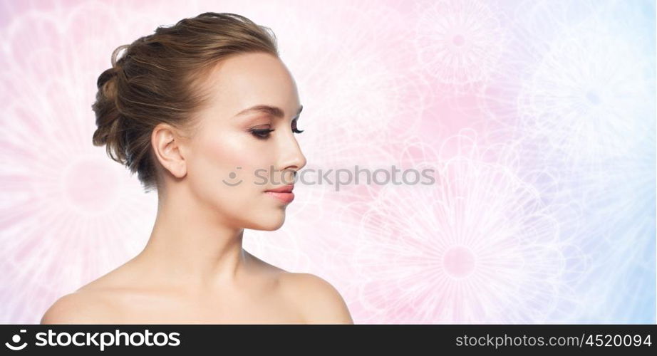 health, people, plastic surgery and beauty concept - beautiful young woman face over rose quartz and serenity patterned background