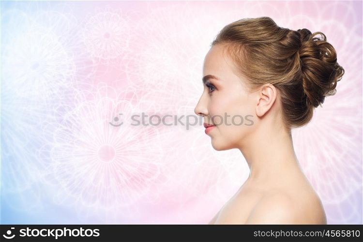 health, people, plastic surgery and beauty concept - beautiful young woman face over rose quartz and serenity pattern background