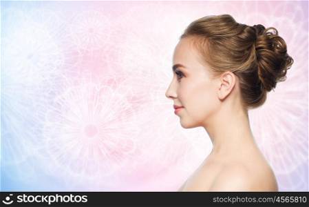 health, people, plastic surgery and beauty concept - beautiful young woman face over rose quartz and serenity pattern background