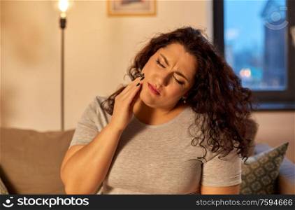 health problem and dental care concept - unhappy woman suffering from toothache at home. unhappy woman suffering from toothache at home