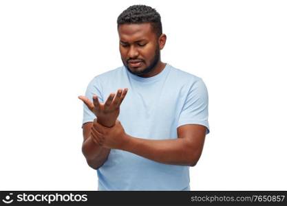 health problem and people concept - unhealthy african american man suffering from pain in hand over white background. african american man suffering from pain in hand