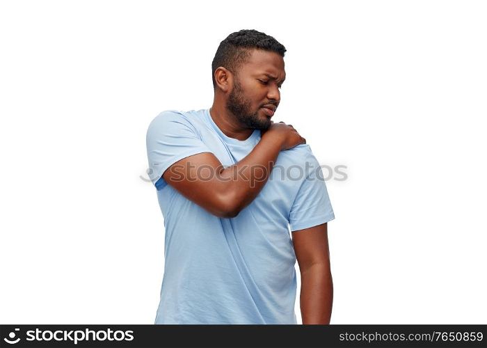 health problem and people concept - unhealthy african american man suffering from shoulder pain over white background. african american man suffering from shoulder pain