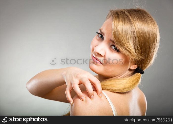 Health problem, skin diseases. Young woman scratching her itchy arm with allergy rash. woman scratching her itchy arm with allergy rash