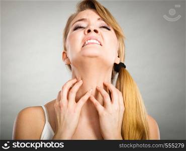 Health problem, skin diseases. Young woman scratching her itchy neck with allergy rash. woman scratching her itchy neck with allergy rash