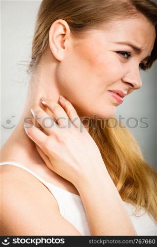 Health problem, skin diseases. Young woman scratching her itchy neck with allergy rash. woman scratching her itchy neck with allergy rash