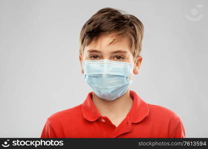 health protection, safety and pandemic concept - boy in protective medical mask over grey background. boy in protective medical mask