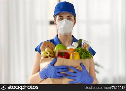 health protection, safety and pandemic concept - delivery woman in face mask and gloves holding paper bag with food. delivery woman in face mask with food in paper bag