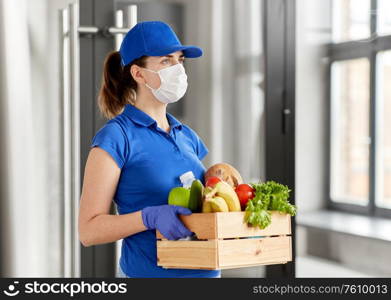 health protection, safety and pandemic concept - delivery woman in face mask and gloves holding wooden box with food. delivery woman in face mask with food in box